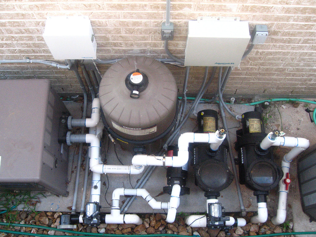Residential pool equipment pad with pumps and filter